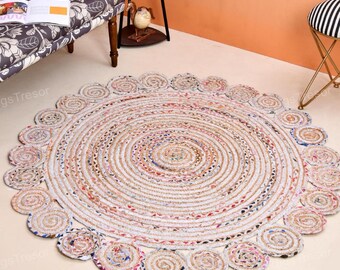 Op de afbeelding: Een ronde jute vloerkleed met een spiraalvormig ontwerp en een decoratieve rand. Het vloerkleed heeft een mix van neutrale en kleurrijke draden, wat een textuurrijke, bohemien uitstraling creëert. Geschikt voor woonkamers en slaapkamers.