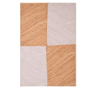 May include: A rectangular rug with a checkerboard design. The rug is split into four squares, alternating between light beige and off-white. The texture looks woven, with visible fibres. The words "RugsTresor" are printed diagonally across the rug.