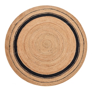 May include: A round jute rug with a natural tan color and a thick black border. The rug has a woven texture and a circular design, suitable for indoor use. The rug's diameter is approximately 60 inches.