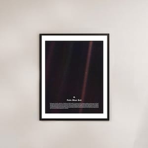 May include: A black framed print of a photograph of a pale blue dot, which is Earth, taken by the Voyager 1 spacecraft. The print includes the text "Pale Blue Dot" and a description of the image.