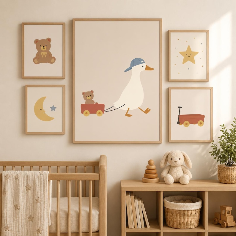May include: A set of five framed wall art prints featuring illustrations of a white duck wearing a blue cap pulling a red wagon with a teddy bear, a brown teddy bear, a yellow crescent moon with a star, a yellow star, and a red wagon.