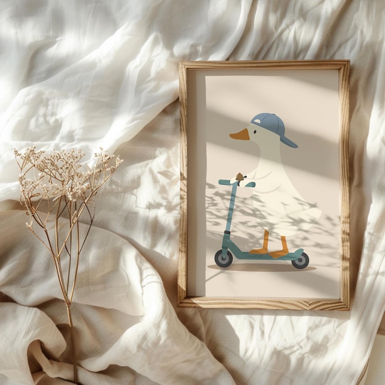 May include: A framed wall art print featuring a white duck wearing a blue baseball cap and riding a teal kick scooter. The duck has an orange beak and orange feet, set against a solid light beige background within a light wood frame.