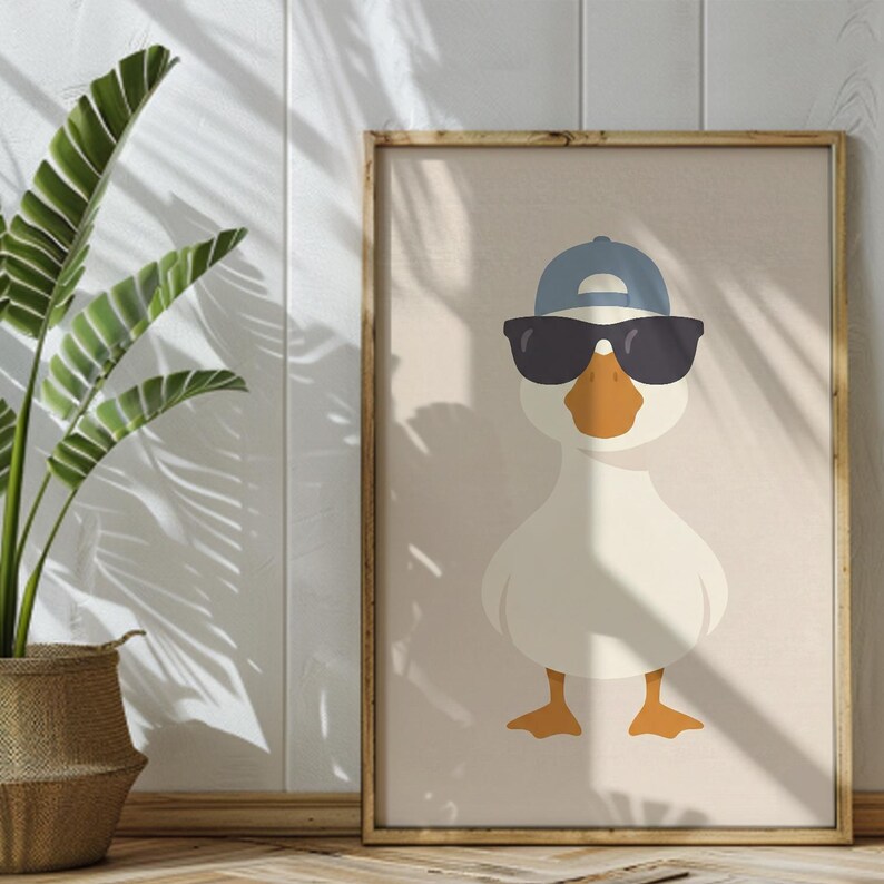 May include: A framed art print featuring a cartoon duck wearing a blue baseball cap and black sunglasses. The duck has an orange beak and feet, set against a beige background. The artwork is in a wooden frame.