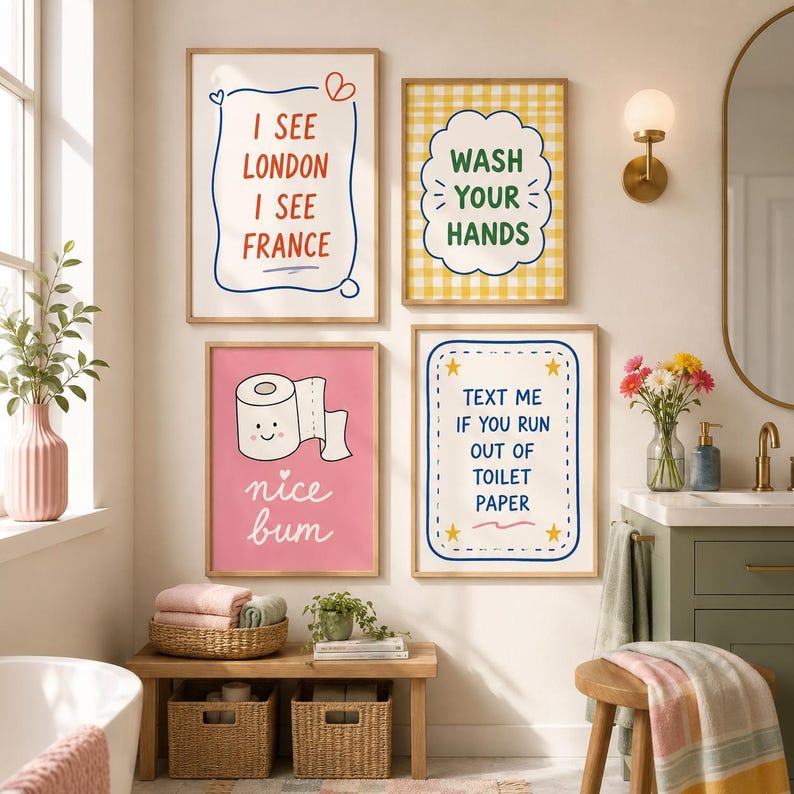 May include: Four framed wall art prints displayed in a bathroom. The prints feature colorful text and illustrations including the phrases I SEE LONDON I SEE FRANCE, WASH YOUR HANDS, nice bum, and TEXT ME IF YOU RUN OUT OF TOILET PAPER.