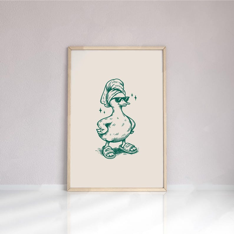 Pu&ograve; includere: Stampa incorniciata di un'anatra dei cartoni animati con occhiali da sole, asciugamano e sandali. Il disegno &egrave; realizzato con inchiostro verde su sfondo crema, incorniciato in una cornice di legno chiaro. Una divertente decorazione murale.