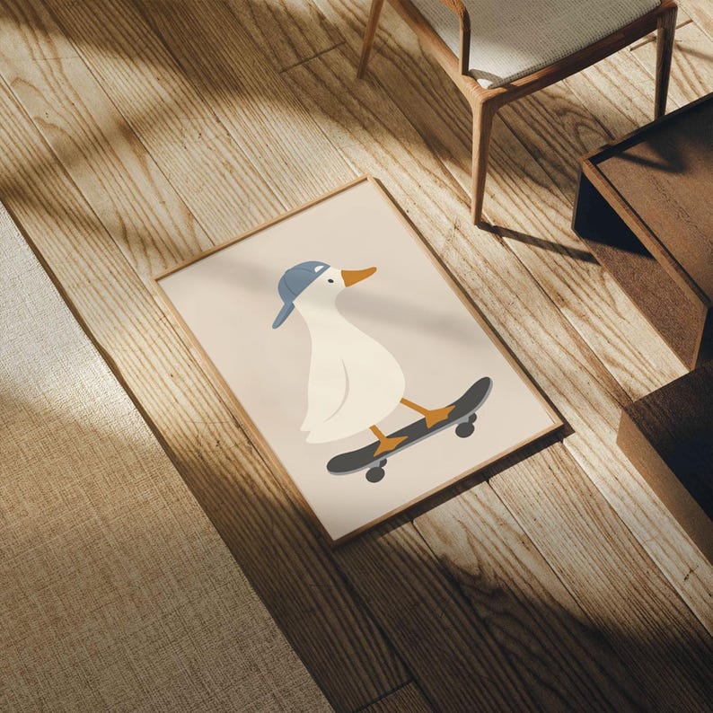 May include: Framed art print featuring a cartoon duck wearing a blue baseball cap and riding a skateboard. The duck is white with an orange beak and yellow feet. The skateboard is black with orange and yellow accents. The print has a beige background and a wooden frame.