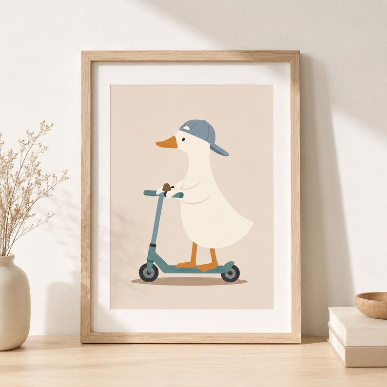 May include: A framed wall art print featuring a white duck with an orange beak wearing a blue baseball cap. The duck is standing on a blue kick scooter against a solid light beige background. The frame is made of light-colored wood.