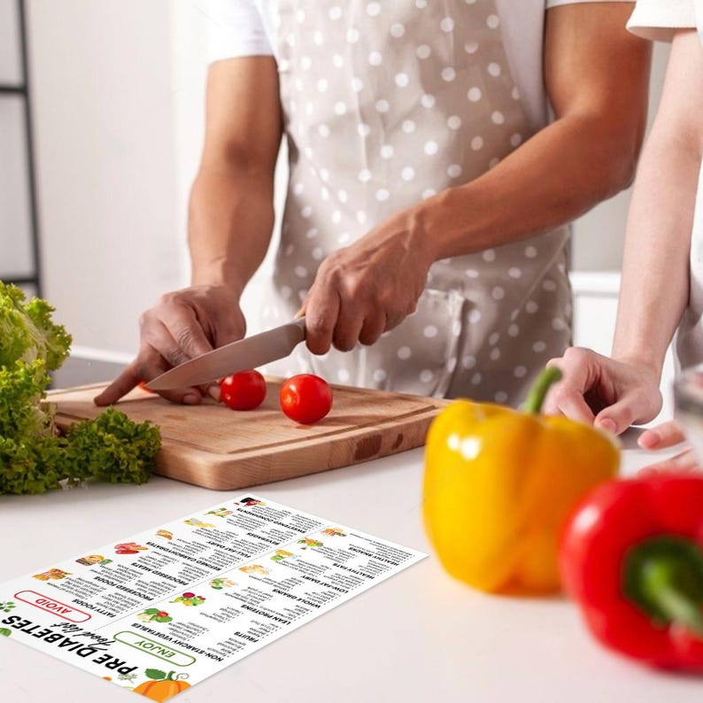 May include: A printable guide to a pre-diabetes diet. The guide lists foods to enjoy and avoid. The image shows a person chopping vegetables on a wooden cutting board. There are red tomatoes, a yellow bell pepper, and a red bell pepper on the counter.