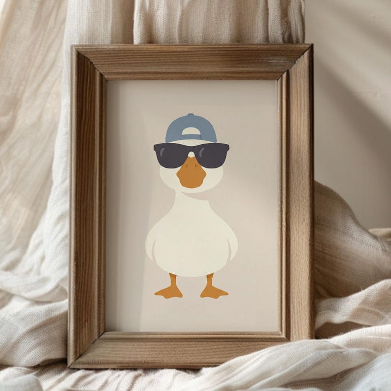 May include: Framed art print featuring a cartoon duck wearing sunglasses and a blue baseball cap. The duck has an orange beak and feet, set against a neutral background. The wooden frame adds a rustic touch.