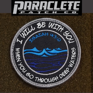 May include: A gray embroidered patch with a blue and white wave design. The text on the patch reads "I will be with you when you go through deep waters" and "Isaiah 43:2".