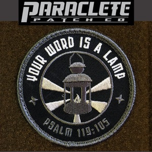 May include: A black and gray embroidered patch with a white lantern and the text "Your Word Is A Lamp" and "Psalm 119:105".