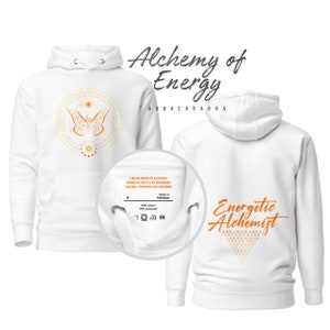 May include: White hoodie with a front design of a butterfly and sun in a circle, and the text "Alchemy of Energy" and "ABRACADABRA". The back features the text "Energetic Alchemist" and "ABRACADABRA". The hoodie has a front pocket and a drawstring hood.