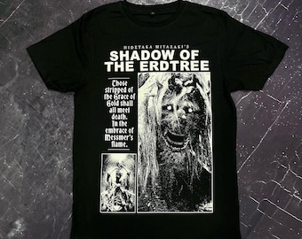 May include: Black t-shirt with a white graphic print of a creature with a large mouth and the text "HIDETAKA MIYAZAKI'S SHADOW OF THE ERDTREE Chose stripped of the Grace of Gold shall all meet death. In the embrace of Messmer's flame."