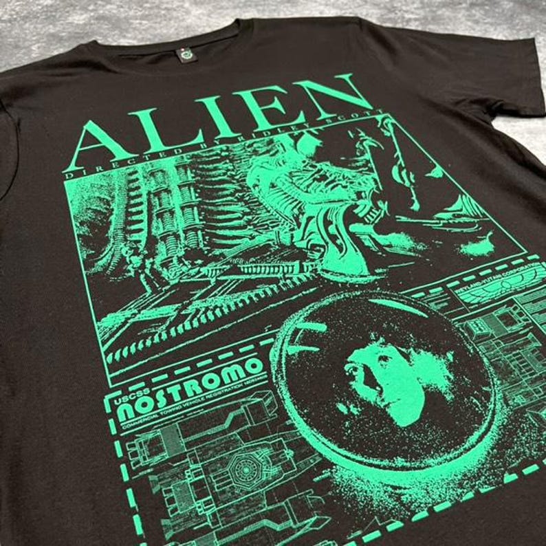 May include: Black t-shirt with a green graphic print of the alien from the movie "Alien" directed by Ridley Scott. The graphic includes the text "Alien" and "USCSS Nostromo".