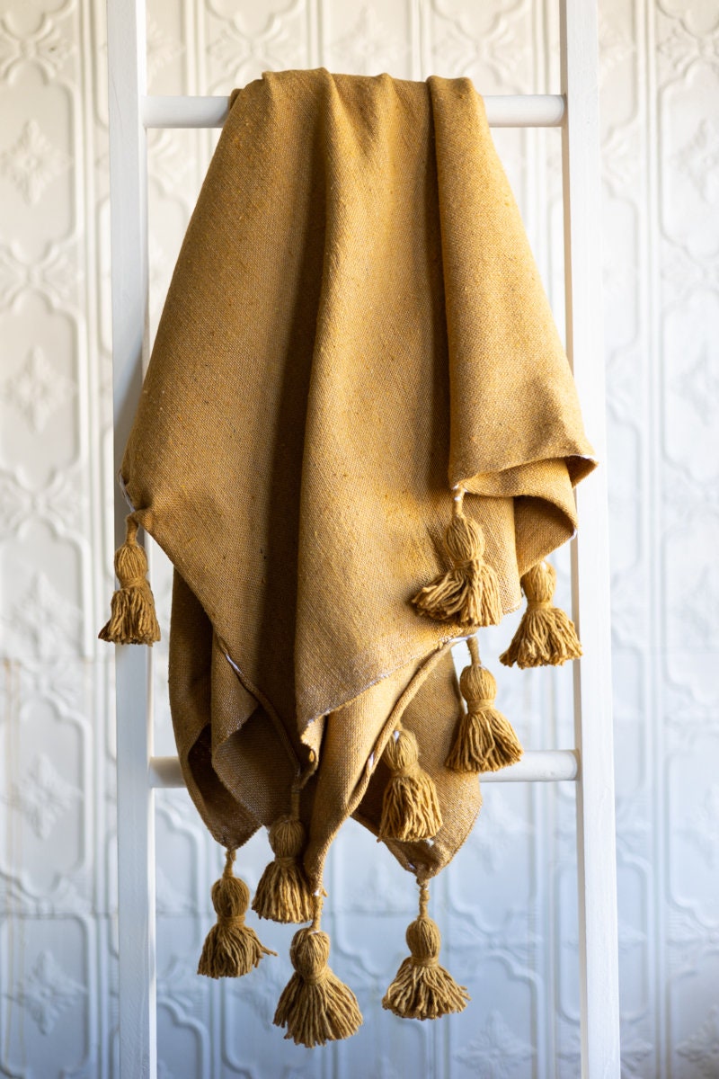 Yellow throw blanket with pom poms sale