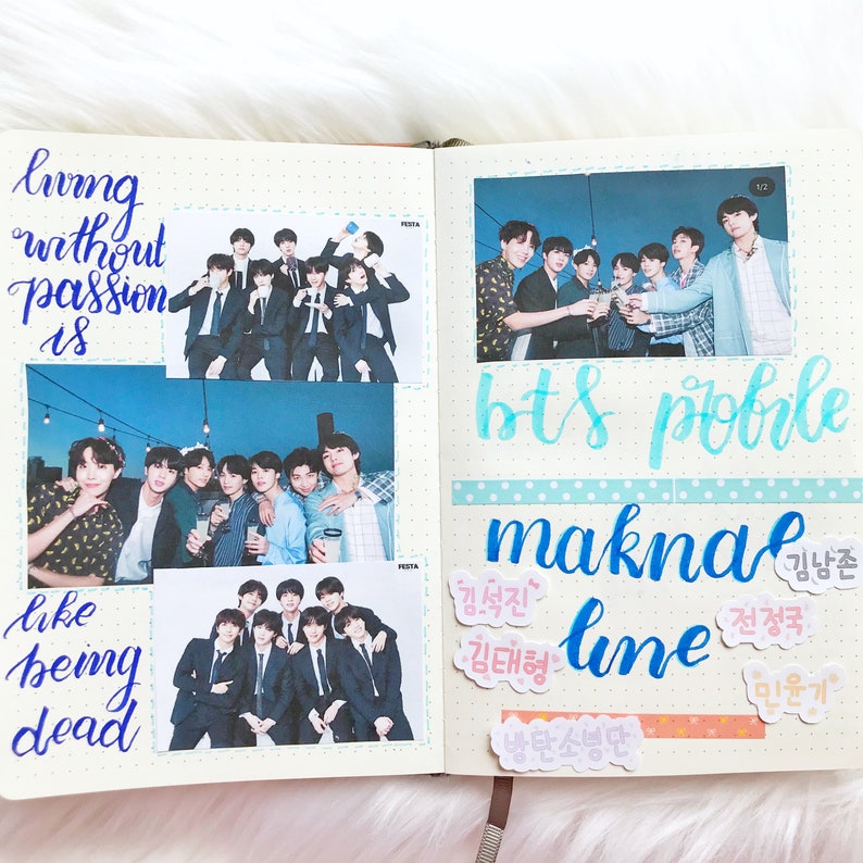 May include: A scrapbook page with photos of a K-pop group, BTS. The page is decorated with blue and white washi tape, stickers, and handwritten text in Korean and English. The text includes the words "bts pohle", "maknae line", and "living without passion is like being dead".