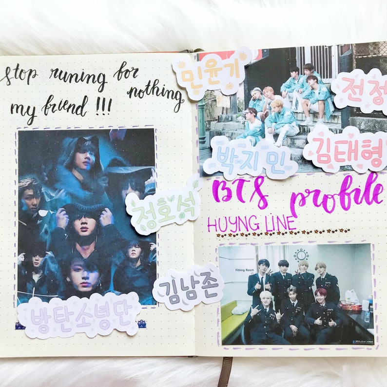 May include: A notebook page with a photo of a K-pop group, BTS, and handwritten notes in Korean. The notes include the names of the members, "Min Yoongi", "Jung Hoseok", "Kim Namjoon", "Park Jimin", "Kim Taehyung", and "Jeon Jungkook". The page also includes the text "BTS profile" and "HYUNG LINE".