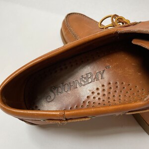 May include: Close-up of the inside of a brown leather loafer with the brand name "St. John's Bay" printed on the insole.