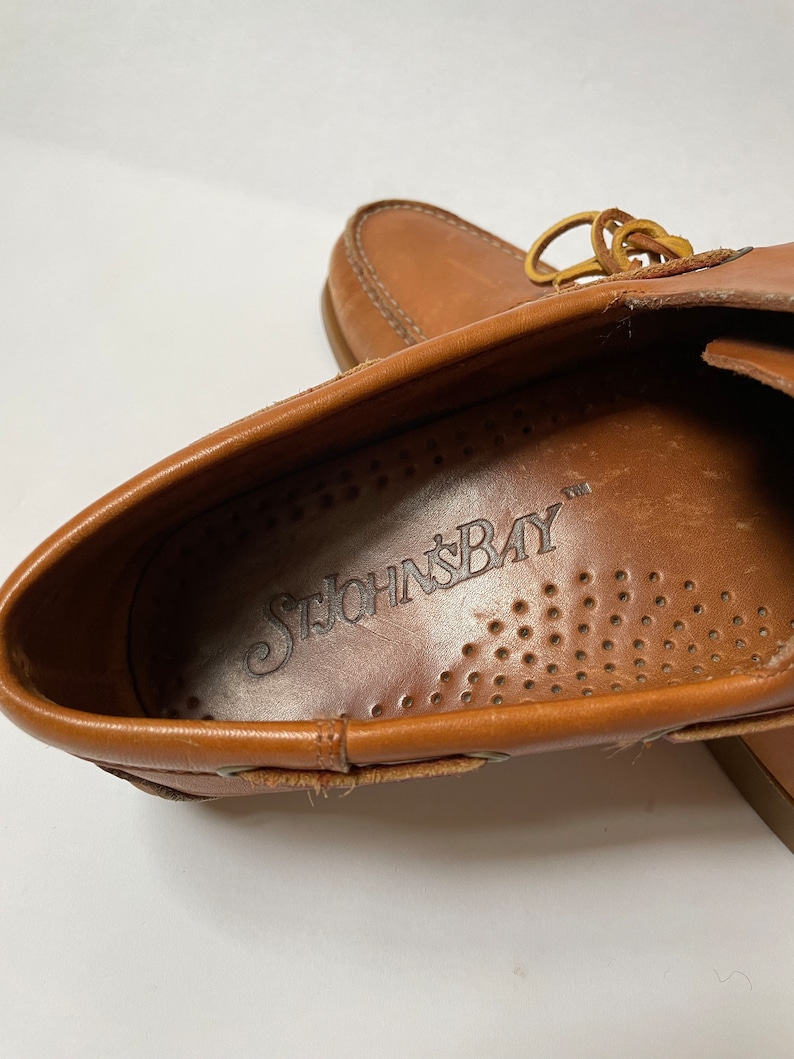May include: Close-up of the inside of a brown leather loafer with the brand name "St. John's Bay" printed on the insole.