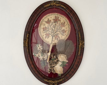 Antique picture with embroidered fan, feathers and silk flowers