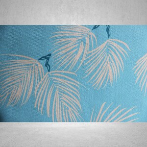 May include: A close-up of a blue fabric with a repeating pattern of white palm leaves. The leaves have detailed veins and are arranged across the surface. The fabric has a textured appearance, suggesting a woven material.