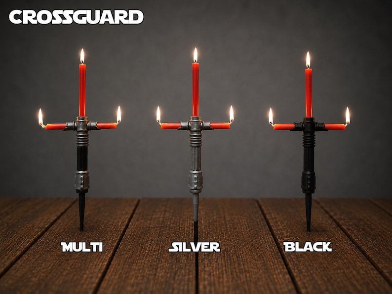 May include: Three candle holders shaped like crossguard hilts, each holding three lit red taper candles. The holders are labeled Multi, Silver, and Black, with the text CROSSGUARD at the top. The designs feature metallic-style handles.