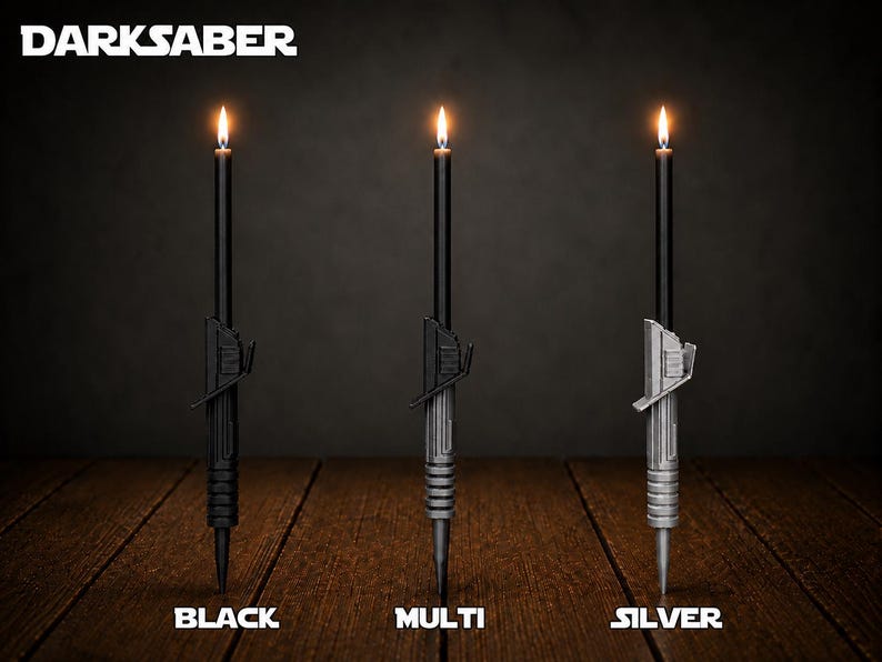 May include: Three black taper candles with hilt-shaped bases labeled DARKSABER. The hilts are black, multi-colored, and silver. Each candle is lit with a small flame at the top. The labels below read BLACK, MULTI, and SILVER in white text.