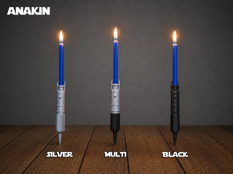 May include: Three lit blue taper candles held in cylindrical holders resembling lightsaber hilts. The holders are labeled as silver, multi, and black. The text ANAKIN appears in the top left corner, with labels silver, multi, and black below.