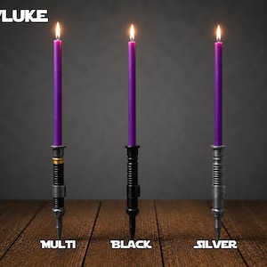 May include: Three tall purple taper candles with lit flames, each held in a different metallic-style base. The bases are labeled Multi, Black, and Silver. The text OBI/LUKE appears in the top left corner of the image.