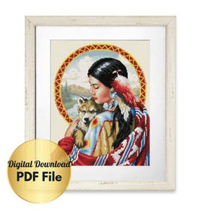 Puede incluir: Un patrón de punto de cruz que presenta a una mujer nativa americana con cabello negro largo, usando un chal estampado en rojo, azul y blanco, sosteniendo un cachorro de lobo blanco. El fondo es un paisaje colorido con un borde circular.