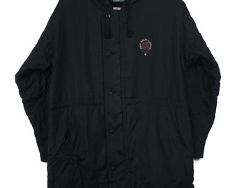 May include: A black hooded long-sleeved jacket with a plaid lining. The jacket has a zip and button fastening, and a drawstring at the waist. The jacket has a logo on the chest that says "Polo Ralph Lauren".