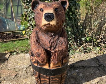 Chainsaw carved bear in a barrel.