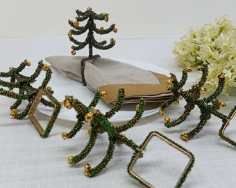 A set of 4 green and gold Christmas tree beaded napkin rings