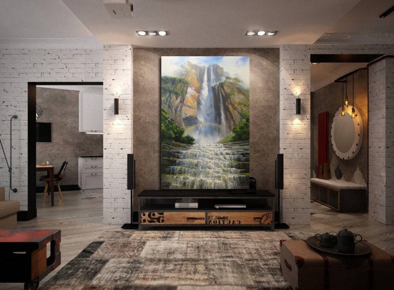 May include: A large painting of a waterfall cascading down a rocky cliffside, surrounded by lush green foliage. The painting is displayed on a wall in a modern living room with a black entertainment center and a rug.