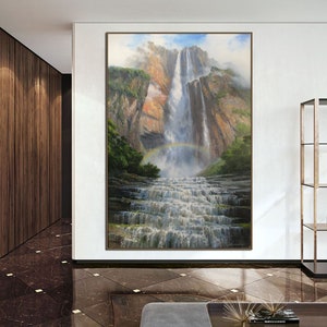 May include: A painting of a waterfall cascading down a rocky cliff face. A rainbow arches over the waterfall, with lush green foliage surrounding the base.