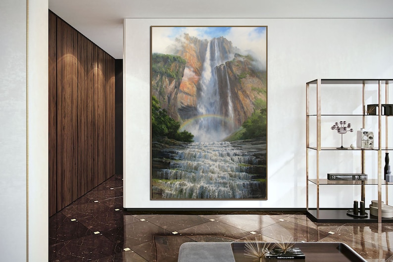 May include: A painting of a waterfall cascading down a rocky cliff face. A rainbow arches over the waterfall, with lush green foliage surrounding the base.