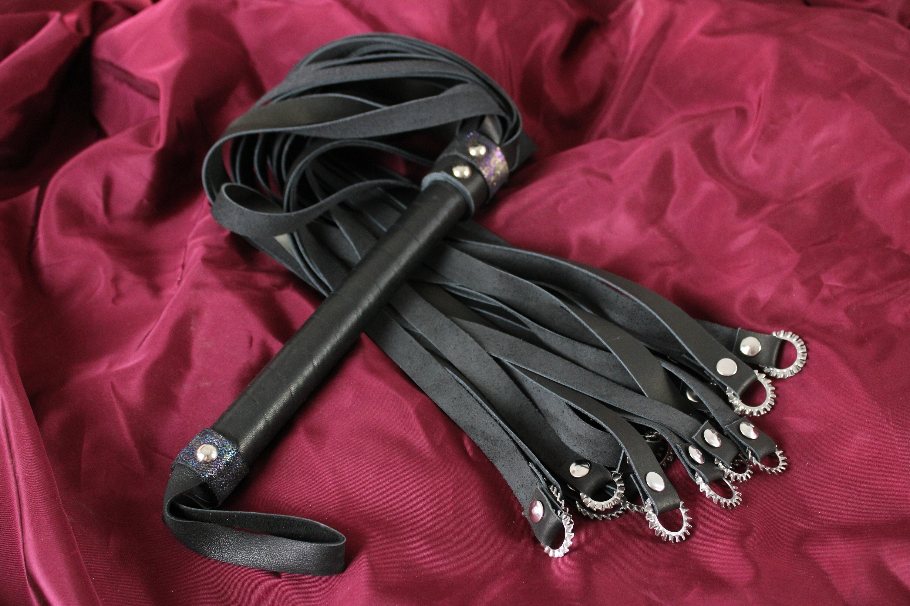 BDSM vampire flogger, steel rings and leather