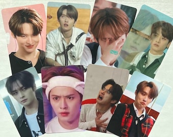 May include: A set of nine photo cards featuring different expressions of a group of young men. The cards are printed on white cardstock and have a glossy finish.