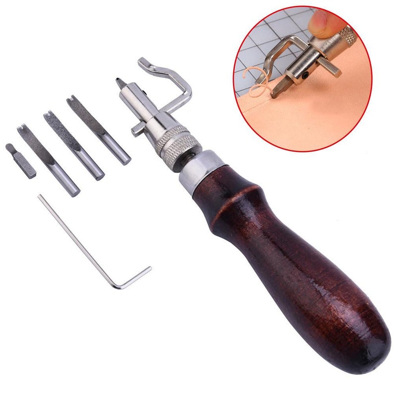 May include: A leather sewing awl tool with a wooden handle and a set of interchangeable needles. The tool is used for stitching leather and other materials.