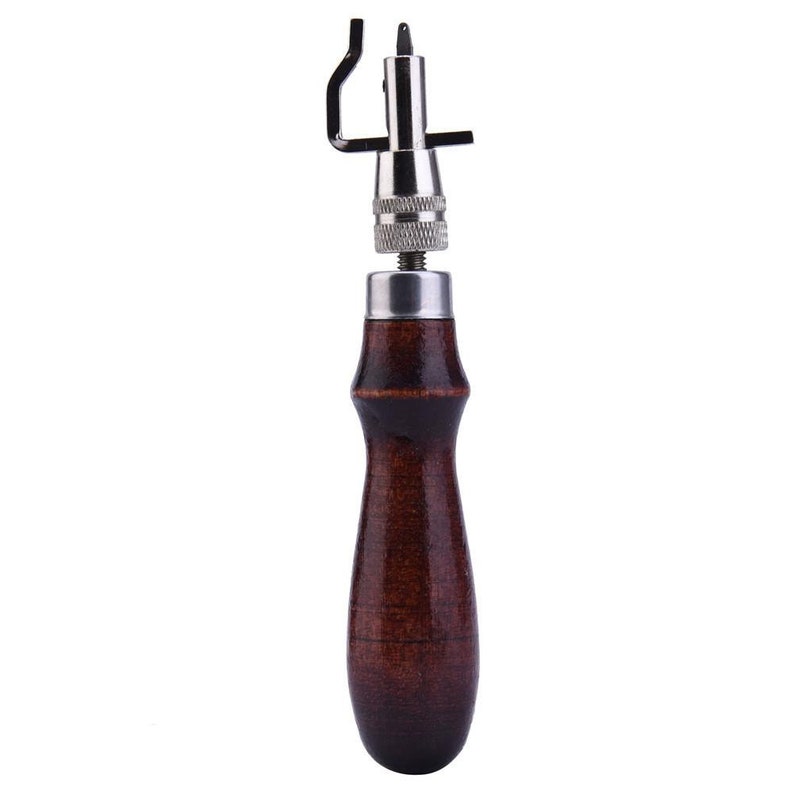May include: A brown wooden handled leather stitching awl with a metal needle and adjustable guide.
