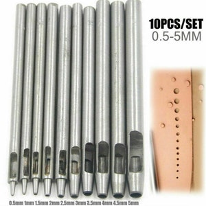 May include: Set of 10 silver metal leather hole punches, ranging in size from 0.5 mm to 5 mm. The punches are arranged in order of size, with the smallest punch on the left and the largest punch on the right. The text "10PCS/SET 0.5-5MM" is printed on a white background.