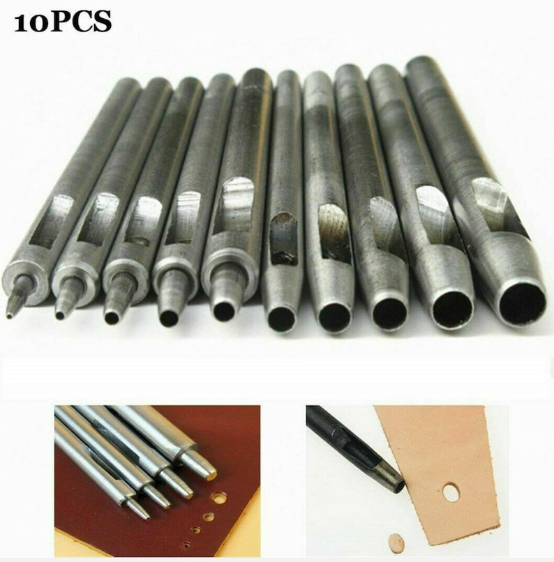 May include: Set of 10 silver metal leather hole punch tools. The tools are lined up in order of size, with the smallest on the left and the largest on the right. The tools are used to punch holes in leather for sewing or other crafts.