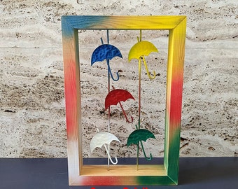Bronze umbrellas in a wooden frame. Multicolor painted umbrellas, home decor, decoration,umbrellas decorative.