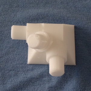 May include: White plastic 3D printed corner piece with three protruding cylinders.