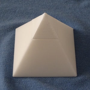 May include: A white foam pyramid shape.