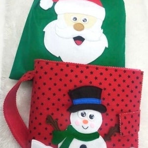 May include: A green Christmas gift bag with a Santa Claus face and a red drawstring. A red book-shaped container with a snowman design, black star pattern, and a red handle.