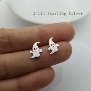 May include: A pair of silver ghost stud earrings.  Solid Sterling Silver.