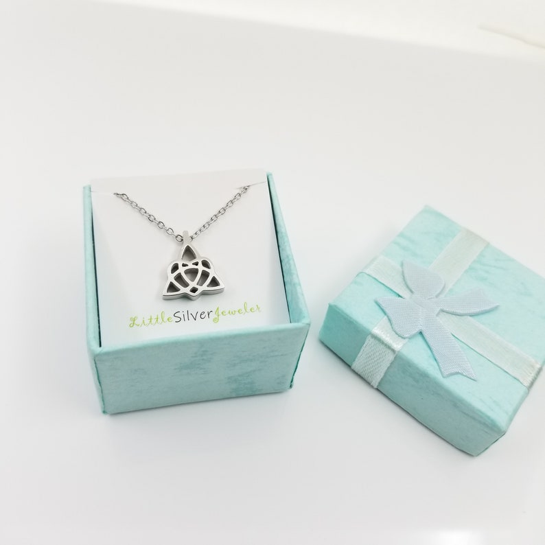 May include: A silver Celtic knot pendant necklace in a light blue gift box with a white ribbon. The box has the text "LittleSilverjeweler" printed on it.