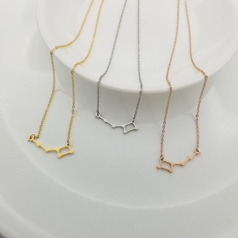 May include: Three delicate necklaces with a constellation design. The necklaces are available in gold, silver, and rose gold.
