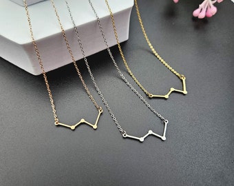 May include: Four delicate gold, silver, and rose gold necklaces with a constellation design. Each necklace features a small, simple constellation pendant.